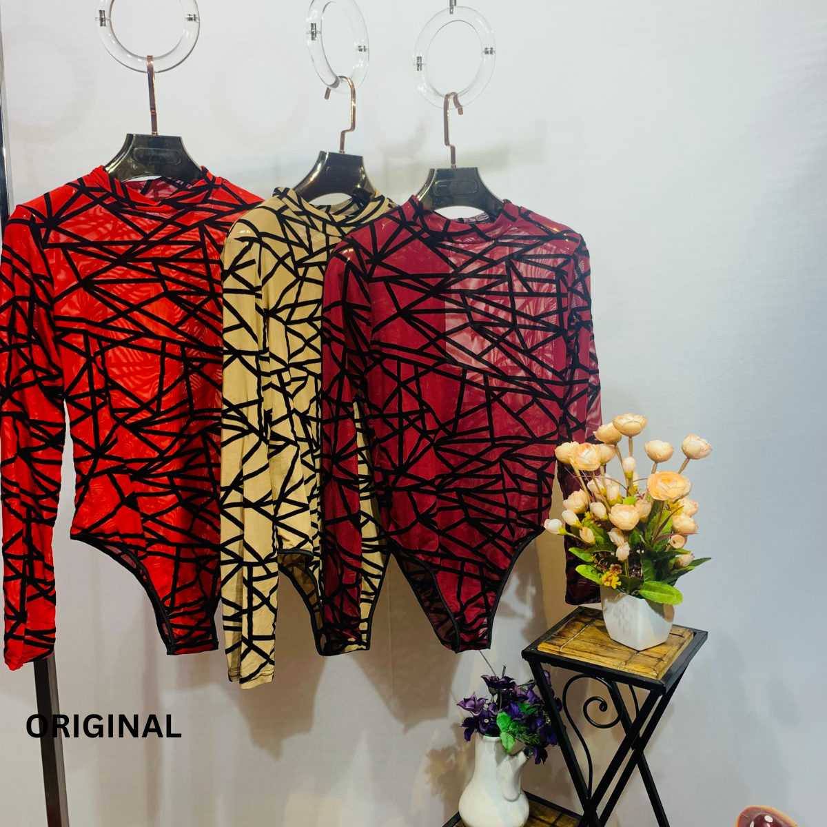 This bodysuit features a geometric print pattern