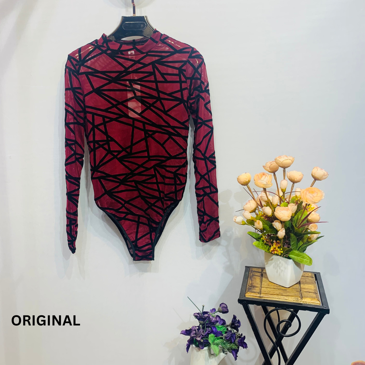 This bodysuit features a geometric print pattern